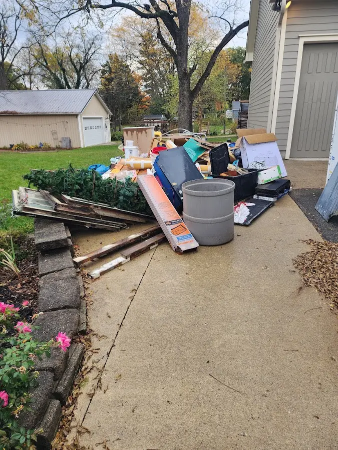 Dumpster being loaded with debris for Roofing Dumpster Rental in Rye